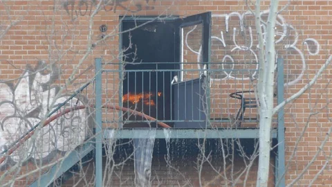 Flame viewed while burning inside a vacant building with leaking water Stock Footage 88698580