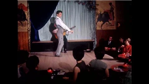 A flamenco dancer dances on a stage in a Spanish restaurant and a drunk diner Stock Footage 139640641