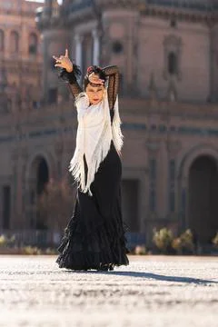 Flamenco dancer dancing with passion on a square Stock Photos