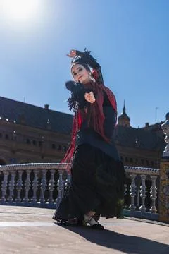 Flamenco dancer facing the camera while dance outdoors Stock Photos