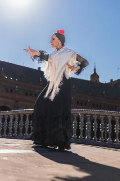 Flamenco dancer illuminated by the sun while dancing outdoors Stock Photos