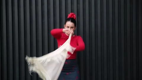 Flamenco dancer performing with white shawl and red rose in hair Stock Footage 303142523