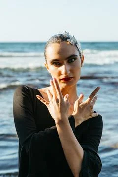 Flamenco dancer posing at seaside during sunset Stock Photos