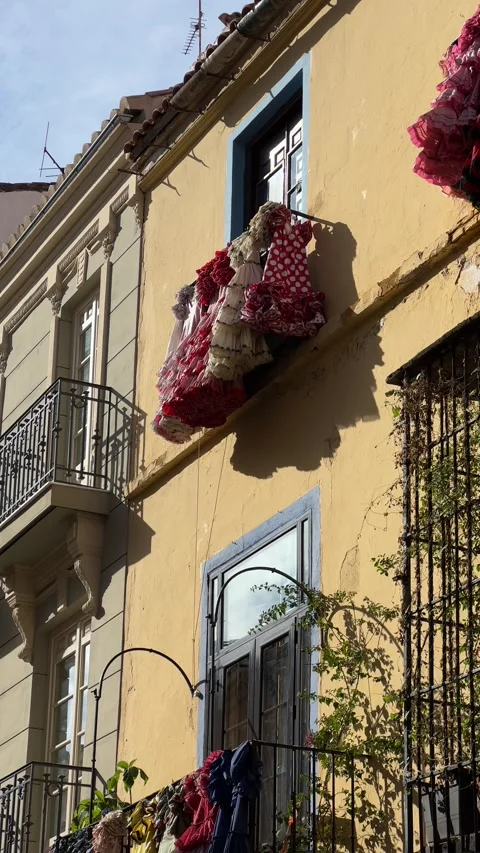 Flamenco dresses hanging from windows in Malaga, Spain. Vertical video Stock Footage 240920317