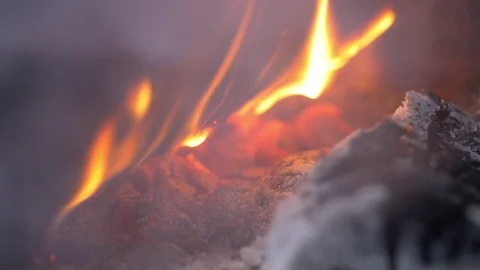 Flames and ash and burning wood in Sami tent close up Stockbeeldmateriaal 70145026