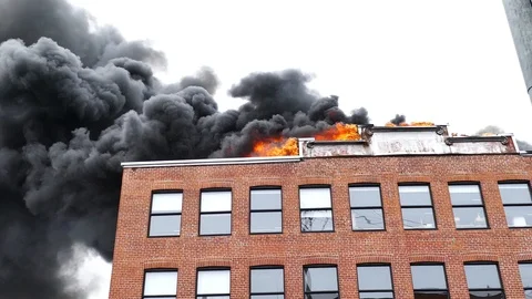 Flames and black smoke on brick building Stock Footage 114946192