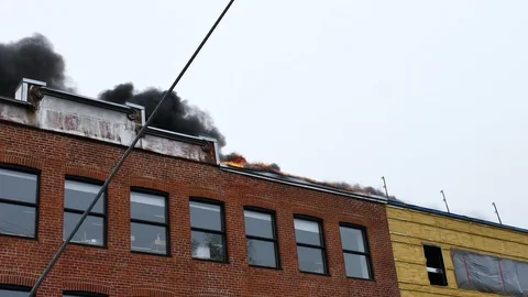 Flames and black smoke on old structure Stock Footage 114946260