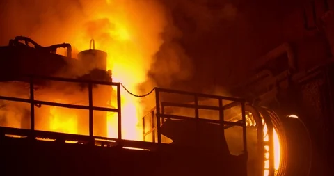 Flames and pra from high temperature. Metallurgical plant is a large furnace for Stock Footage 128578473