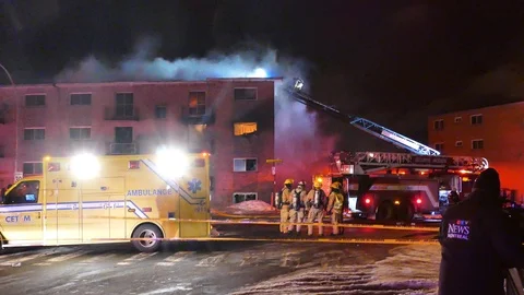 Flames and smoke coming out structure fire Stock Footage 104298178