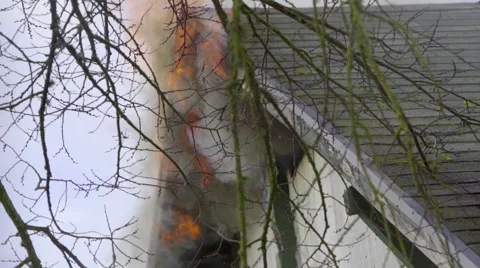 Flames billow from the attic of a house Stock Footage 60795473