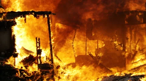 Flames blazing as a house is on fire burning in slow motion Stock Footage