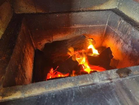 Flames in a brick fireplace Stock Photos