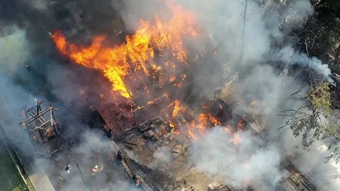 Flames burn as brave firefighters work on a dangerous house and car on fire. 4K Stock Footage 113111802