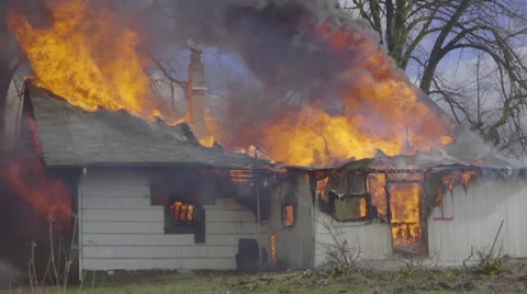 Flames burn through roof Stock Footage 61174752