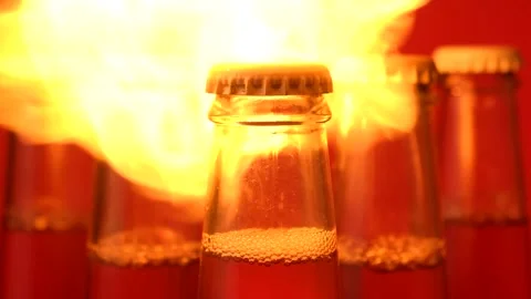 Flames burst out and envelop the five glass bottles of liquid Stock Footage 150685600