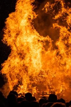 Flames closeup with a crowd in the foreground Stock Photos