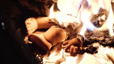 Flames consuming a baby doll Stock Footage 156062246