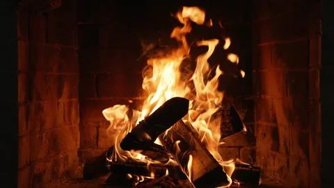 Flames Dance in a Cozy Fireplace, Casting a Warm Glow on the Surrounding Space Stock Footage 317309394