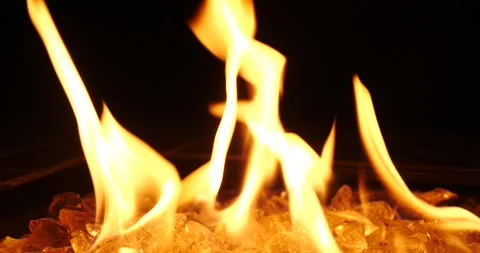 Flames dance over glowing embers in a dark setting Stock Footage 281816244