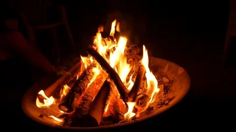 Flames dancing around logs in camp fire. Stock Footage 92663016