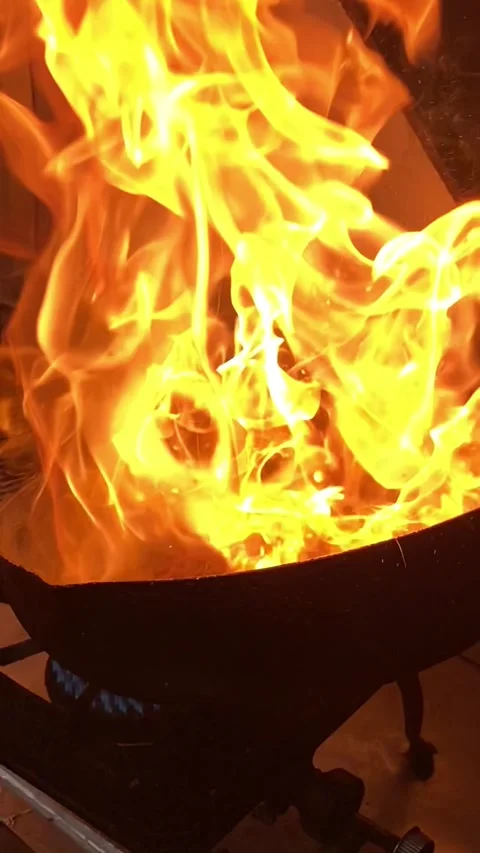 Flames dancing over the wok (wide) Stock Footage 341876080
