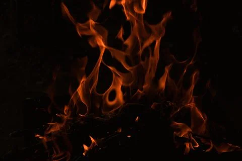 Flames in the dark, a bright fire on a dark background, fire close up Stock Photos
