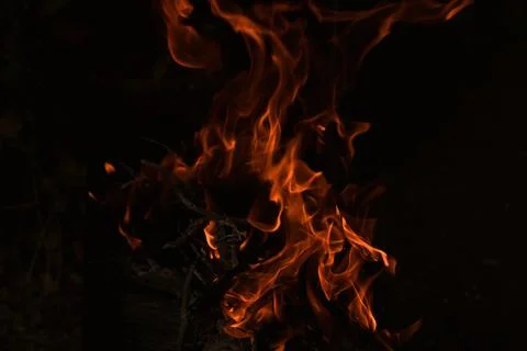 Flames in the dark, a bright fire on a dark background, fire close up Stock Photos