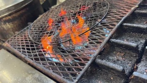 Flames on empty grill grate after grilling steak, gas fire dying down, Japan Stock Footage 342463974