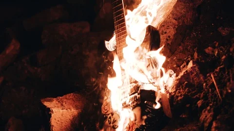 Flames envelop the electric guitar. Burning musical instrument. Close up Stock Footage 114519592