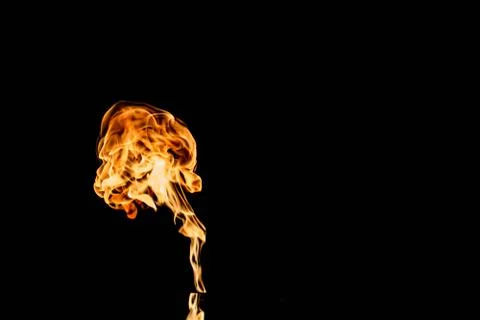 Flames of fire on dark background Stock Photos