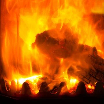 Flames of fire in a fireplace.Abstract background. Stock Photos