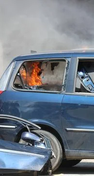 Flames of fire inside the trunk of the car after rioters riot 스톡 사진