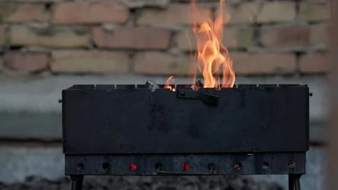 Flames of fire in a slow motion going out of metal barbecue Stock Footage 195092273