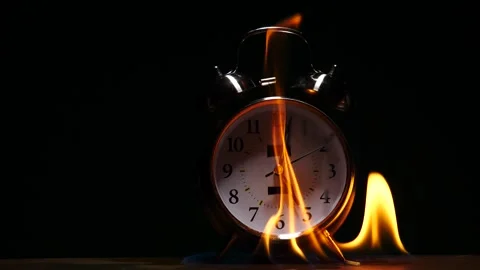 Flames fire surrounding alarm clock and slow motion times up ringing Stock Footage 231745963