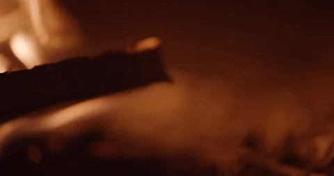 Flames flicker on frame left as focus rolls from foreground to background Stock Footage 102788848