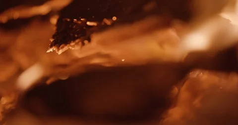 Flames flicker off the tip of burning embers Stock Footage 102788859