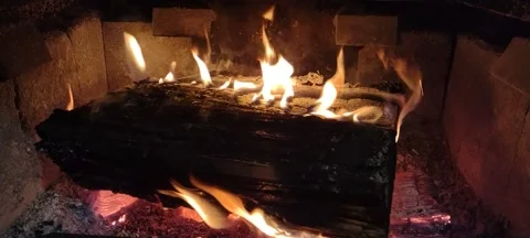 Flames flickering around burning log in rustic wood stove Stock Footage 170996964