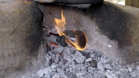 Flames flickering in a rustic fire pit at dusk Stock Footage 311052552