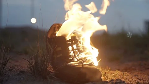 Flames lick sneakers Bright fire illuminates the dark night Stock Footage 95909451