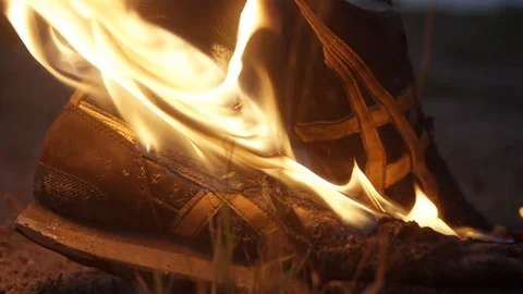 Flames lick sneakers Bright fire illuminates the dark night Stock Footage 95910053