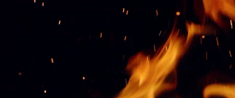 Flames lick in super slow mo as glowing embers rise Stock Footage 136392086