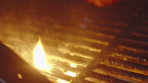 Flames Licking Grill from Below as Burger Patty is Removed from BBQ Stock Footage 343898899