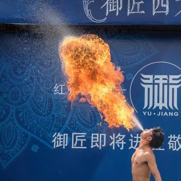 Flames from the mouth of a fire-eater Stock Photos