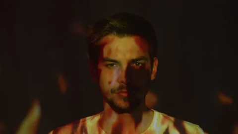 Flames projected onto the face of a man Stock Footage 215165838