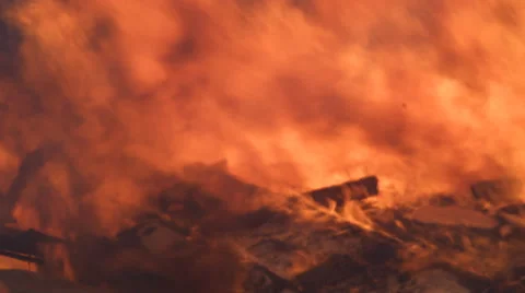 Flames raging above the collapsed wall of a burning house fill the frame Stock Footage 59222279