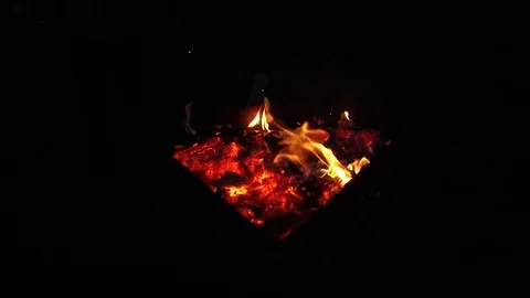 Flames of remainder burning fire in ash. Super slow motion on black. Stock Footage 122809258