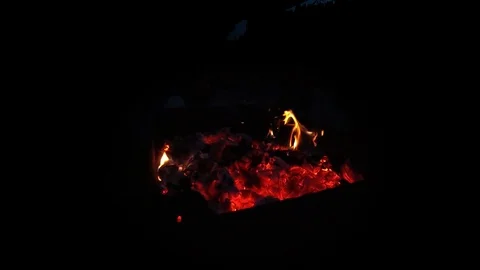 Flames of remainder burning fire in ash. Super slow motion on black. Stock Footage 122809360