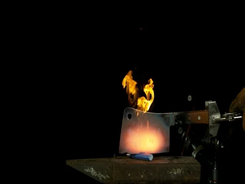 Flames Rise Around a Meat Cleaver Stock Footage 77782353