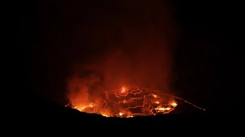 Flames rising from active volcano at night 스톡 동영상 103805723