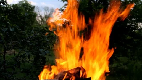 Flames rising and being blown off to the side by the wind Stock Footage 77861096